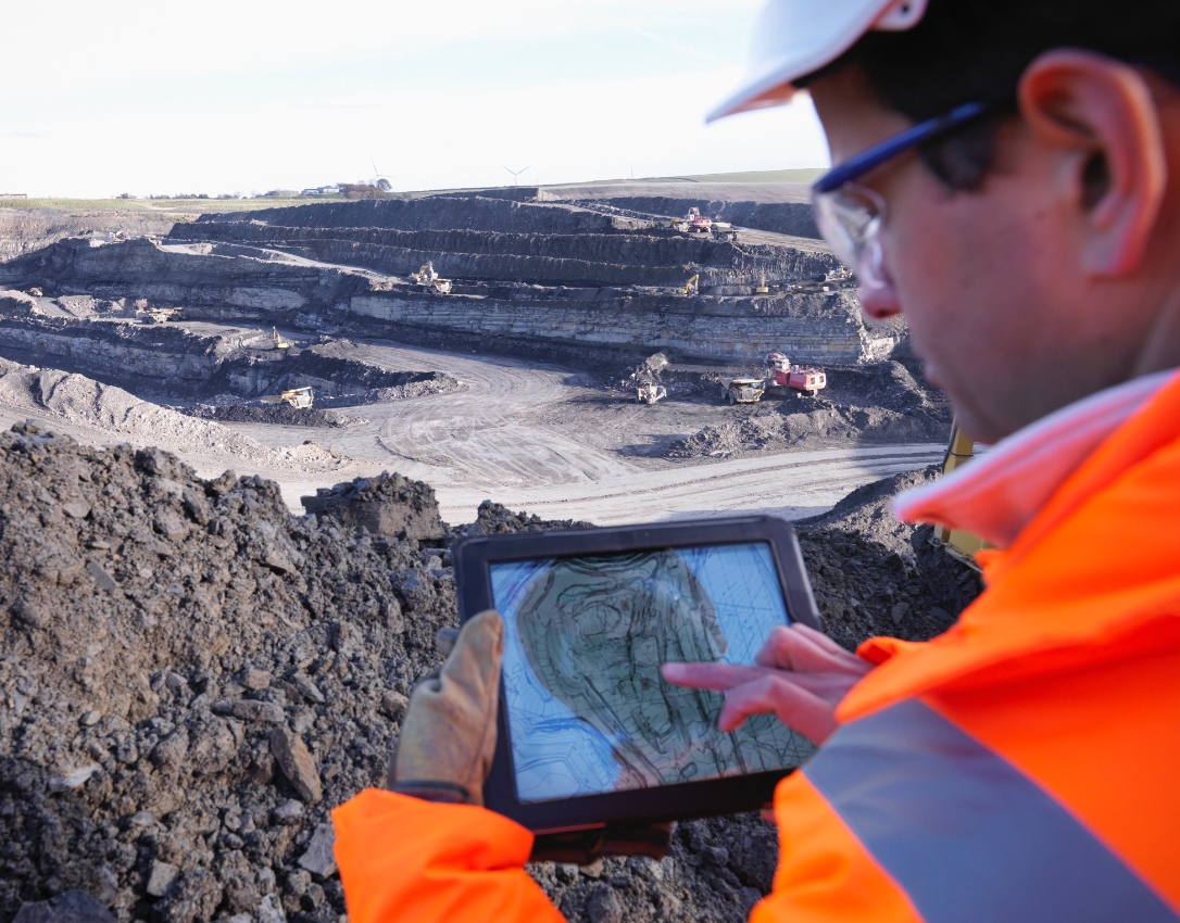 Telstra Business Technology Centre Site manager checking plans on a tablet onsite